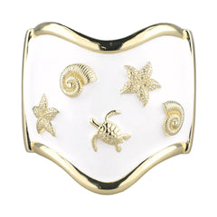 Decorative item with gold turtle, starfish, and shell designs on a white background