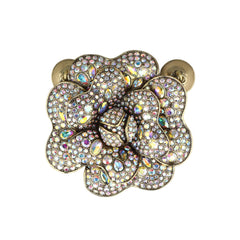 Decorative brooch with multicolored gemstones on a white background