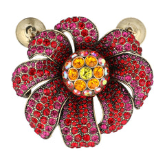 A flower-shaped rhinestone brooch with red and pink petals, a yellow and orange crystal center, and gold-tone post backs, shown on a plain white background.