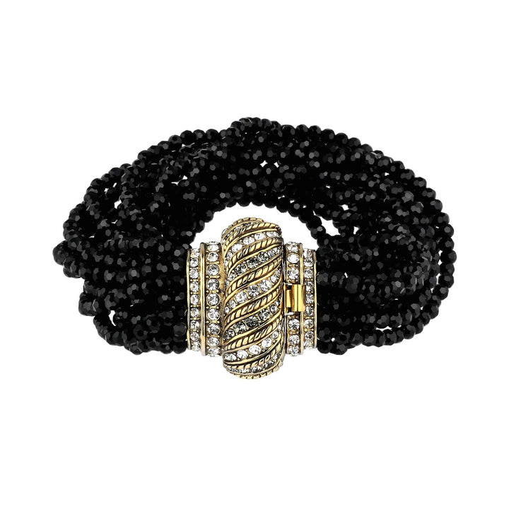 Black beaded bracelet with a gold and silver clasp on a white background