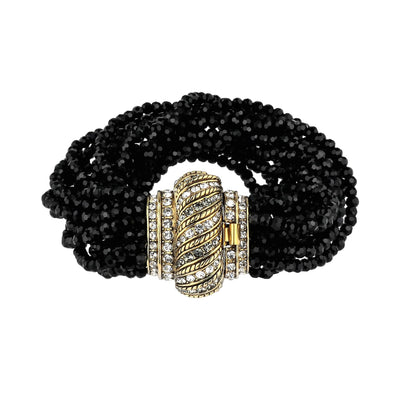 Black beaded bracelet with a gold and silver clasp on a white background