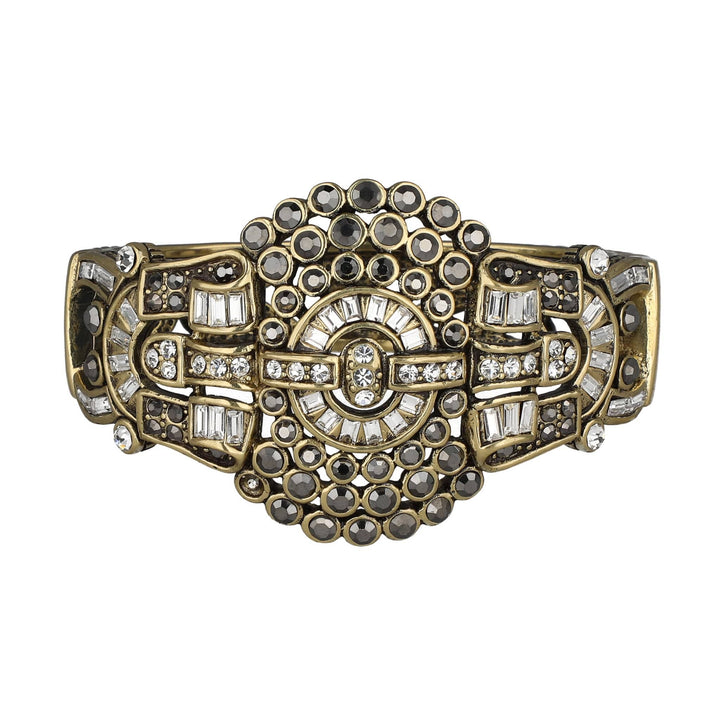 Decorative bracelet with gold, black, and clear gemstones on a white background
