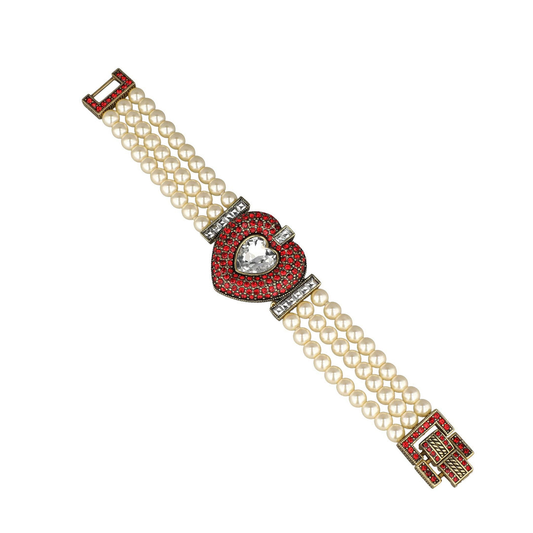 Pearl bracelet with red and silver clasp on a white background