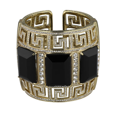 Gold bracelet with black square stones and intricate design on a white background