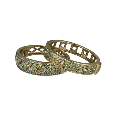 Gold bangles with gemstone accents on a white background. daily double bracelet set by heidi daus