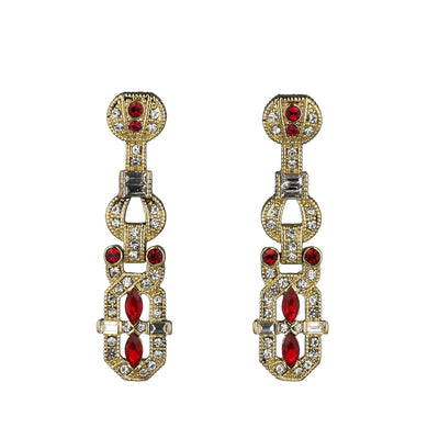 Pair of gold earrings with red and clear gemstones on a white background