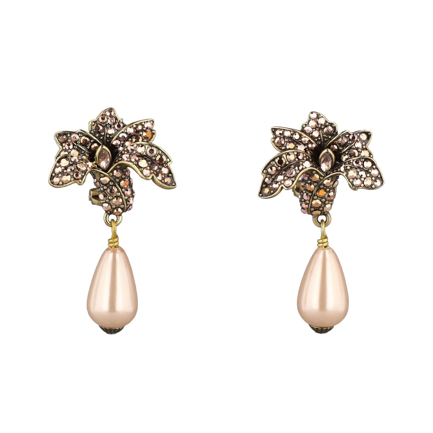 Pair of ornate earrings with floral designs and pearl-like drops on a white background