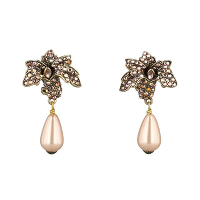 Pair of ornate earrings with floral designs and pearl-like drops on a white background