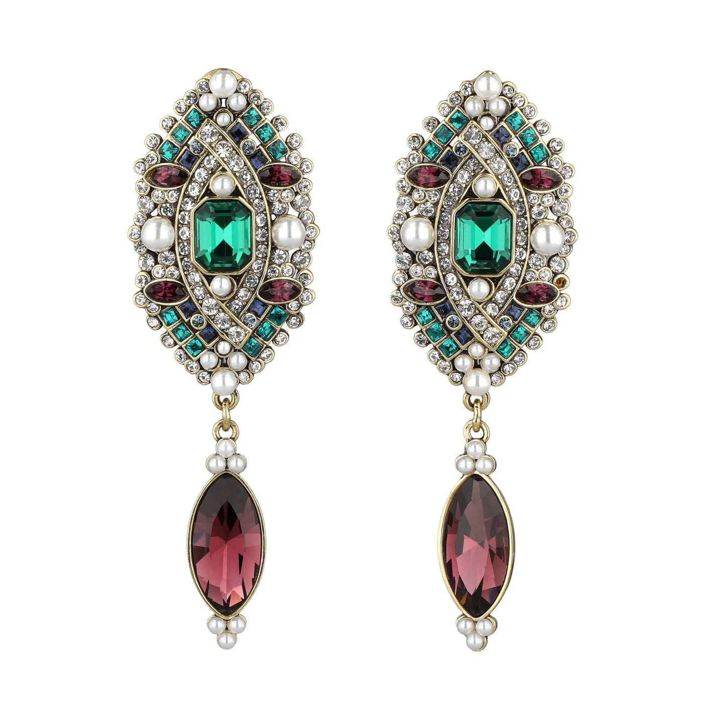 Pair of ornate earrings with gemstones on a white background
