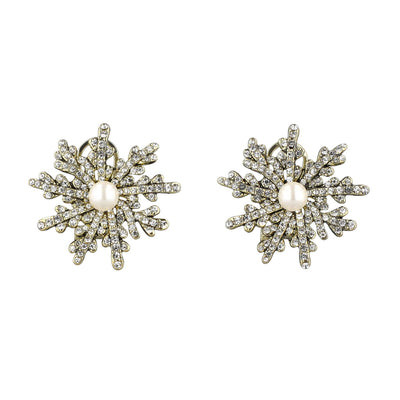 Pair of snowflake-shaped earrings with pearl centers on a white background