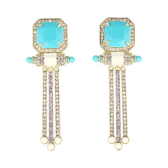 Pair of earrings with turquoise stones and gold accents on a white background
