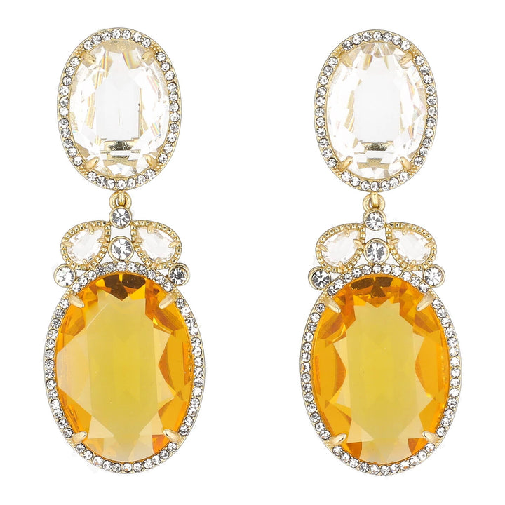 Pair of earrings with yellow gemstones and gold accents on a white background