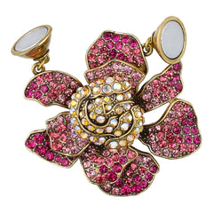 Gold and pink flower-shaped earring with gemstones on a white background