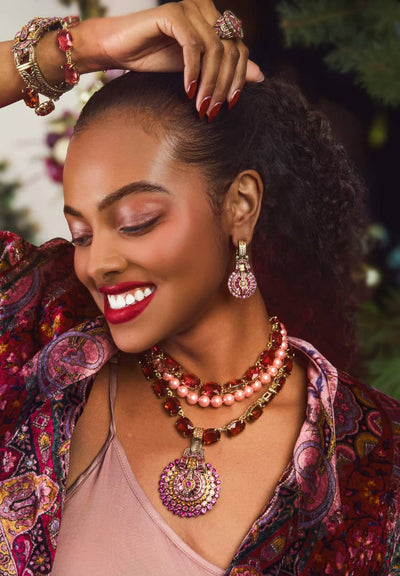 Woman wearing jewelry with a blurred natural background
