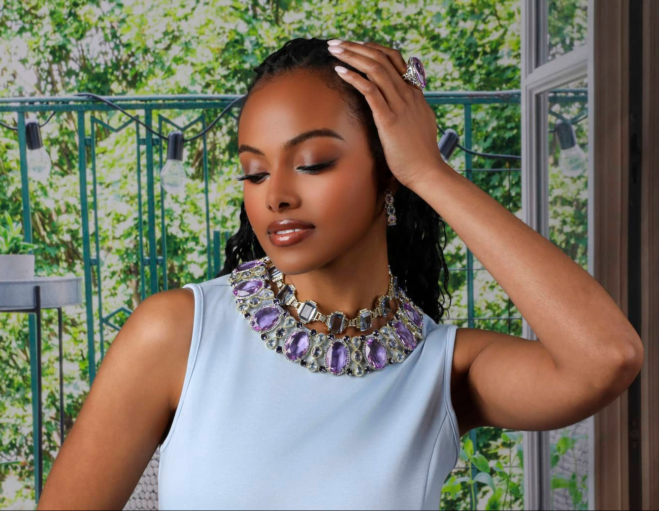 Woman wearing a sparkling necklace with a floral background