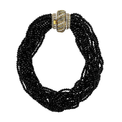 Black beaded necklace with a gold and diamond clasp on a white background