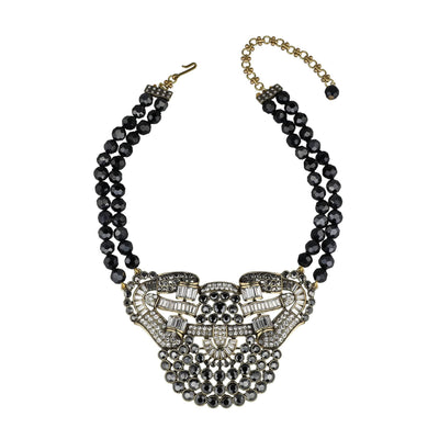 Necklace with black beads and a decorative clasp on a white background