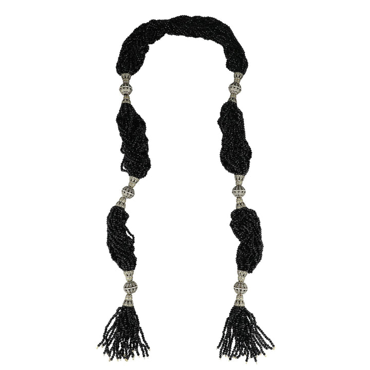 Black beaded necklace with tassels on a white background
