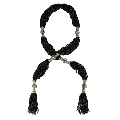 Black beaded necklace with tassels on a white background