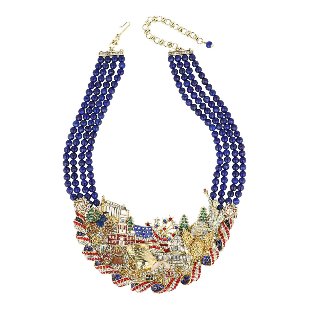 Necklace with blue beads and colorful embellishments on a white background