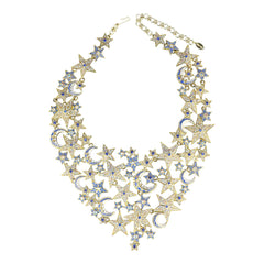Gold necklace with star and moon designs on a white background
