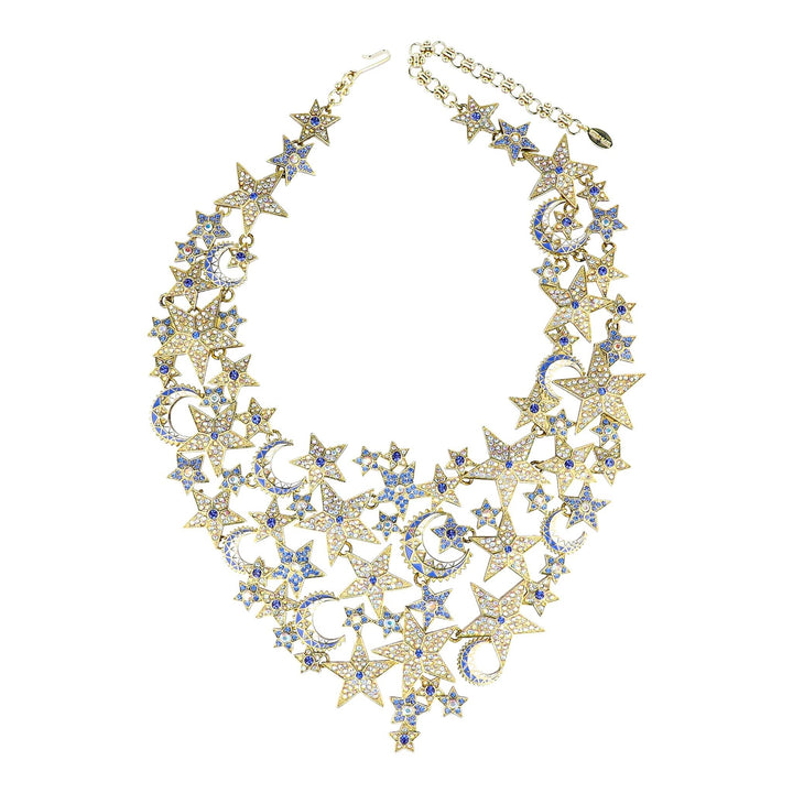 Gold necklace with star and moon designs on a white background