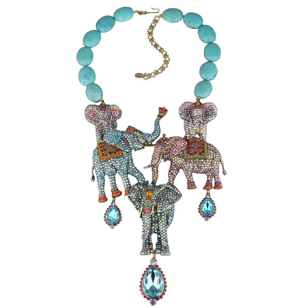 Necklace with elephant pendants and turquoise beads on a white background