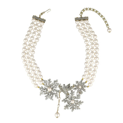 Pearl necklace with snowflake designs on a white background