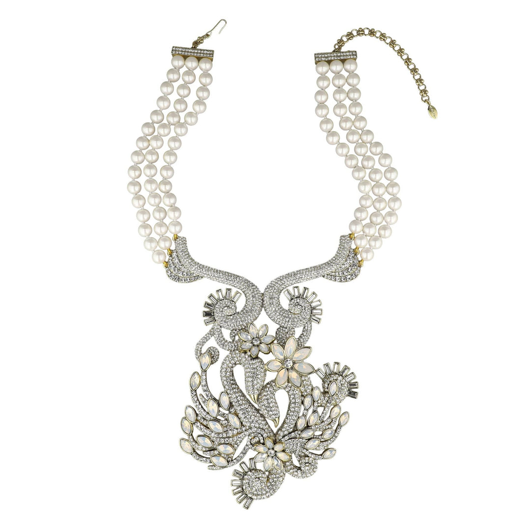 Pearl necklace with intricate silver floral design on a white background