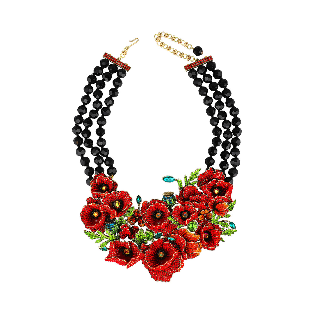 Necklace with black beads and red floral embellishments on a white background