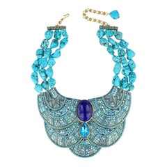 Turquoise beaded necklace with a blue stone pendant on a white background