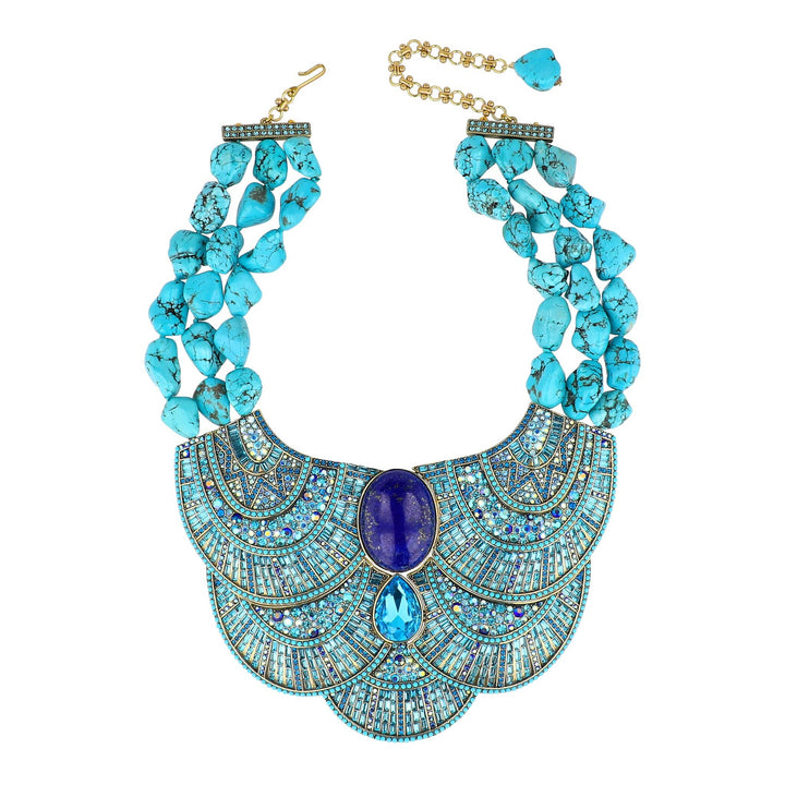 Turquoise beaded necklace with a blue stone pendant on a white background