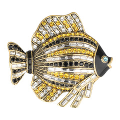 Decorative fish-shaped object with gemstones on a white background