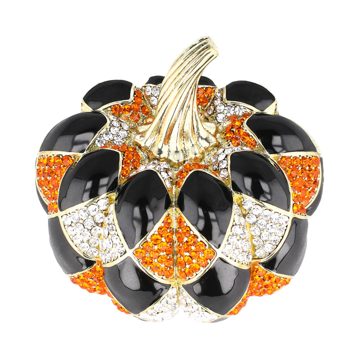 A pumpkin-shaped brooch featuring glossy black enamel sections, orange rhinestone sections, and clear crystal sections, with a gold-tone stem, set against a plain white background.