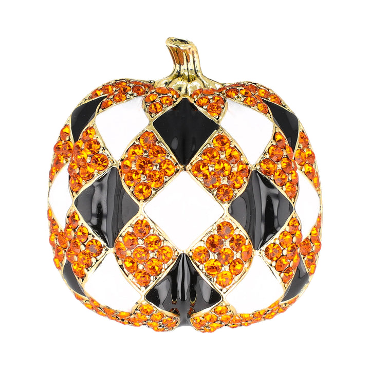 A pumpkin-shaped brooch or ornament featuring a harlequin pattern of orange rhinestones, black enamel, and gold-tone metal outlines on a plain white background.
