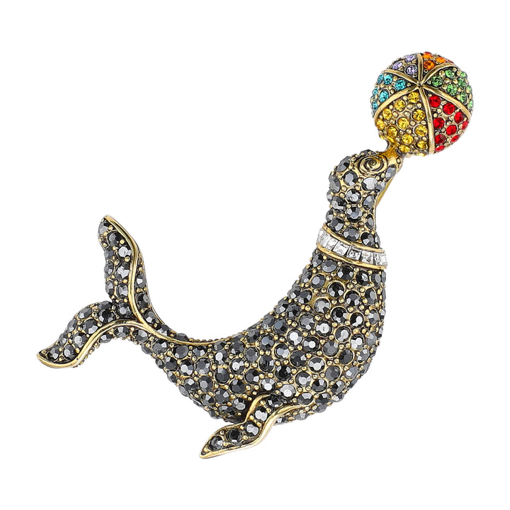 Decorative seal brooch with colorful gemstones on a white background