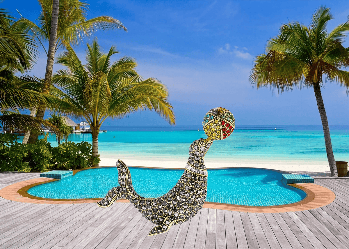 Decorative brooch with a crown on a wooden deck by a pool with palm trees and ocean view.