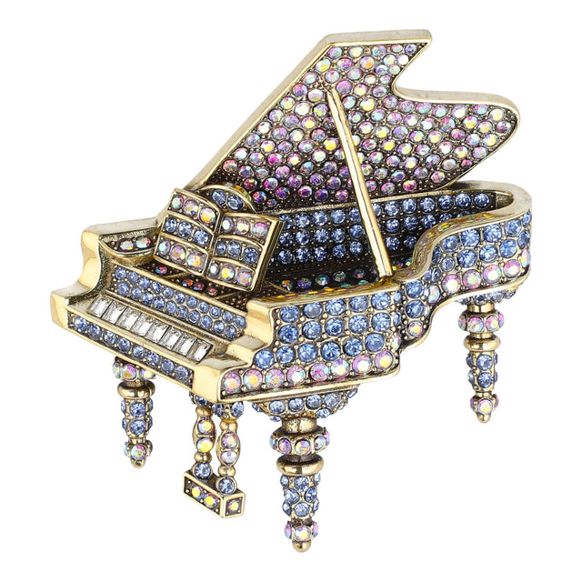 Decorative piano figurine with colorful gemstones on a white background