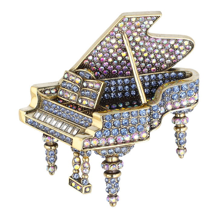 Decorative piano figurine with colorful gemstones on a white background