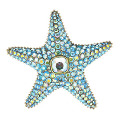 Starfish-shaped object with blue gemstones on a white background