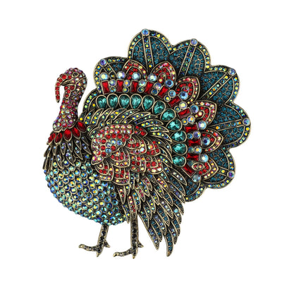 Colorful jeweled turkey brooch on a white background