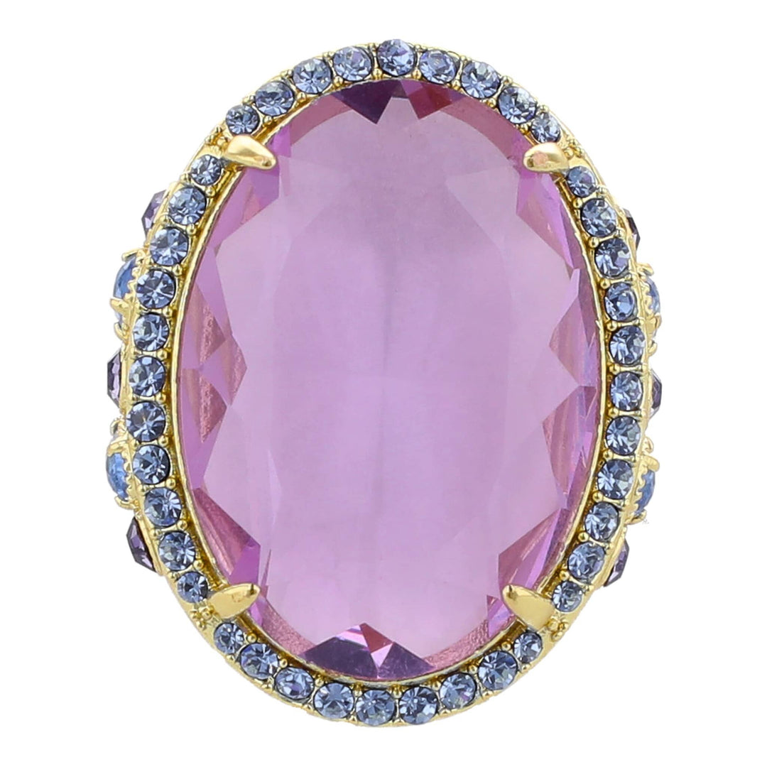 Ring with a pink gemstone and blue gemstones on a white background